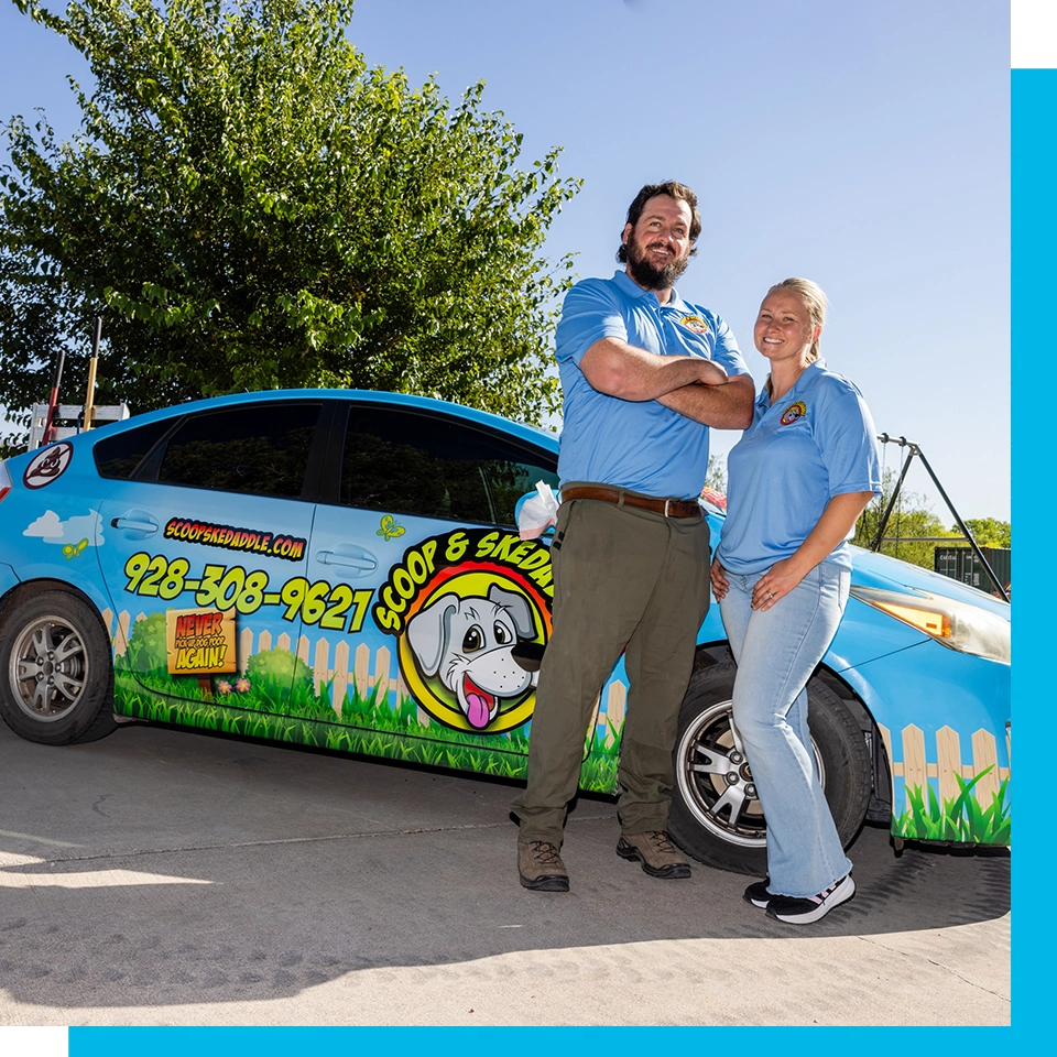 A man and woman standing next to a car.